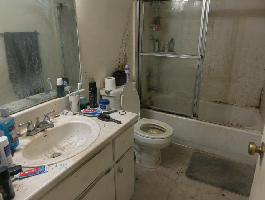 Bathroom before cleaning — grime and clutter