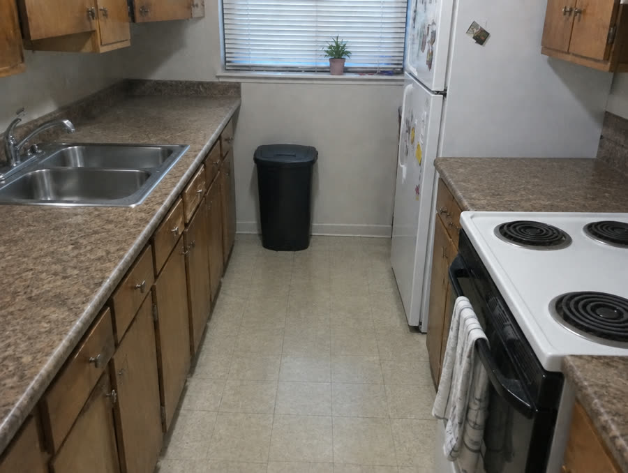 Kitchen after cleaning — clear counters, empty sink